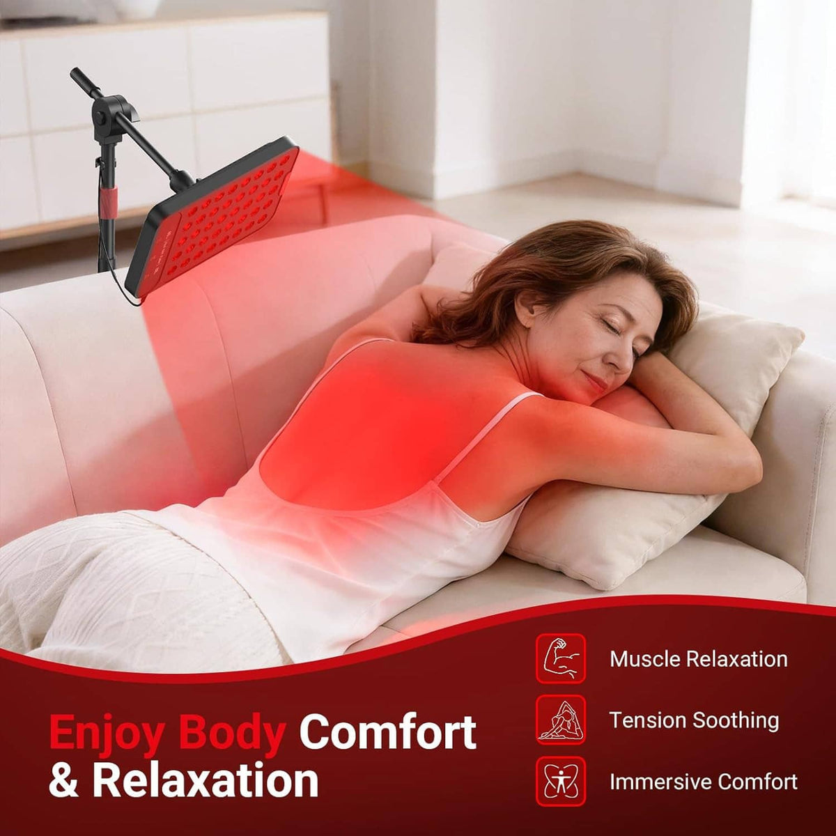 Red light therapy lamp next to couch with glowing red LED panel over user