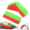 Felt squeegee wrap tools, stacked green plastic frames with red felt edges