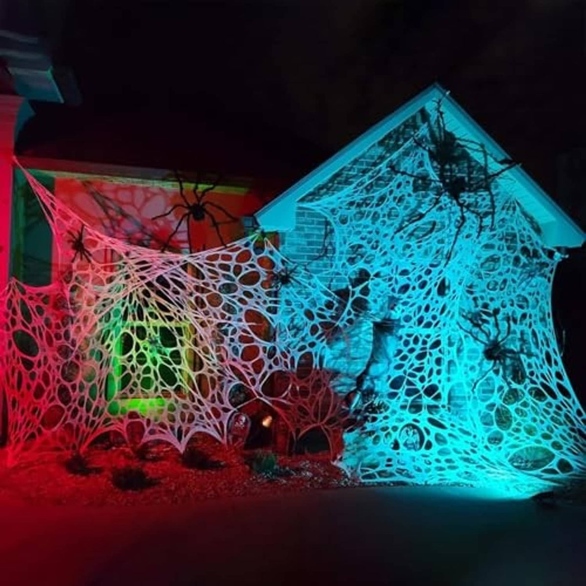 Glowing Halloween spider web decoration with blue and red light and black spiders