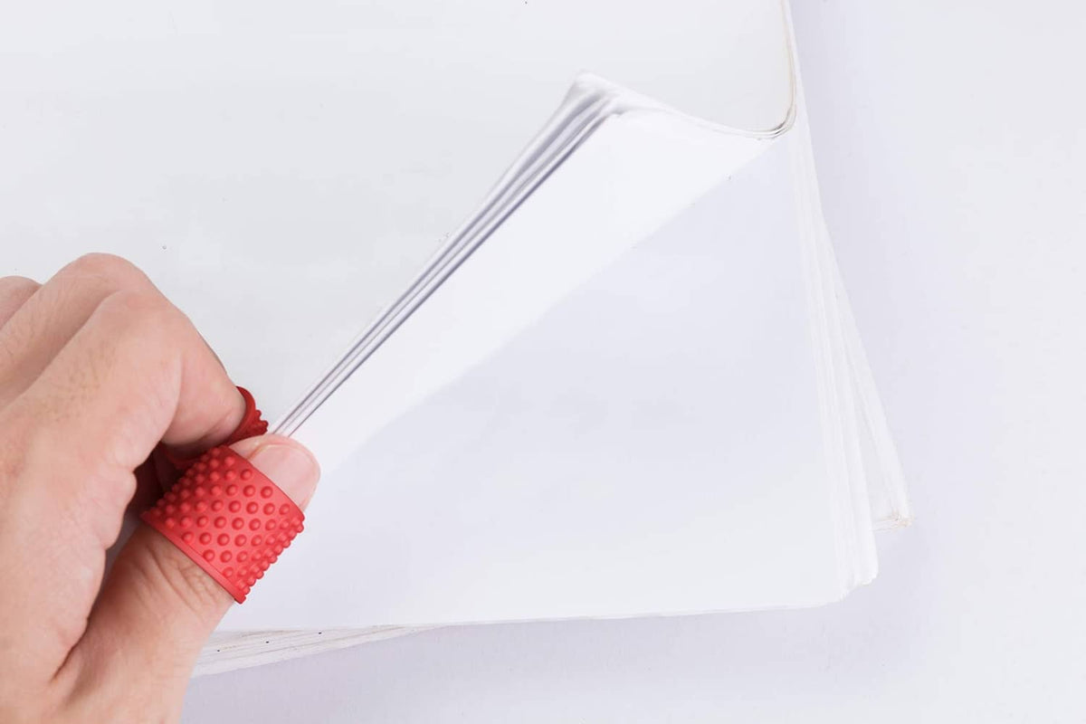 Red finger tip grip ring on a finger securing a plastic bag