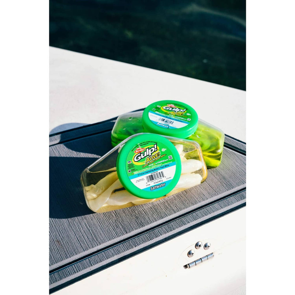 Green Gulp! Alive soft bait container on a boat deck with worm pieces