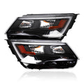 Pair of black headlight assemblies with amber side markers and clear projector lens