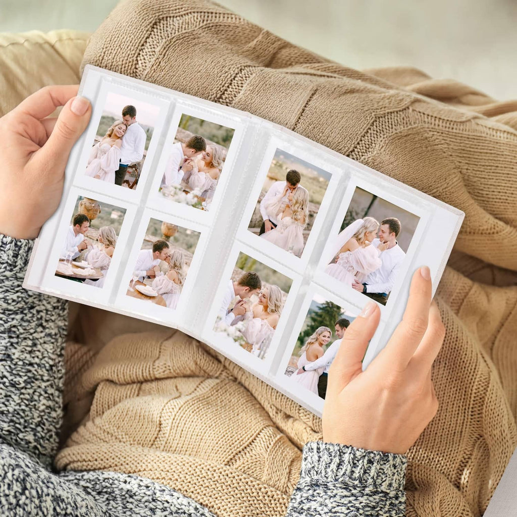 Beige Polaroid photo album held open with clear 2x3 photo grid pages