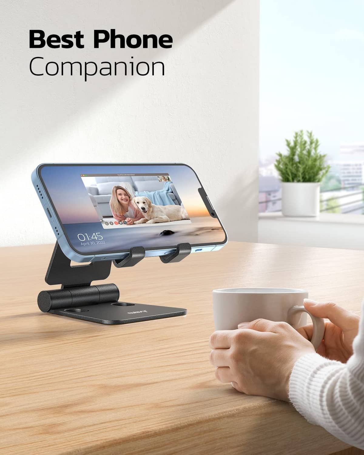 Black phone stand supporting a smartphone with adjustable viewing angle