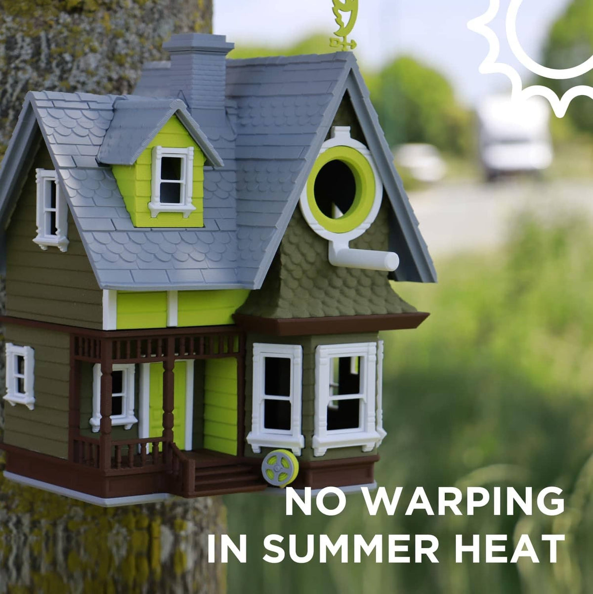 3D printed house model with small windows and roof detail, in summer outdoor light