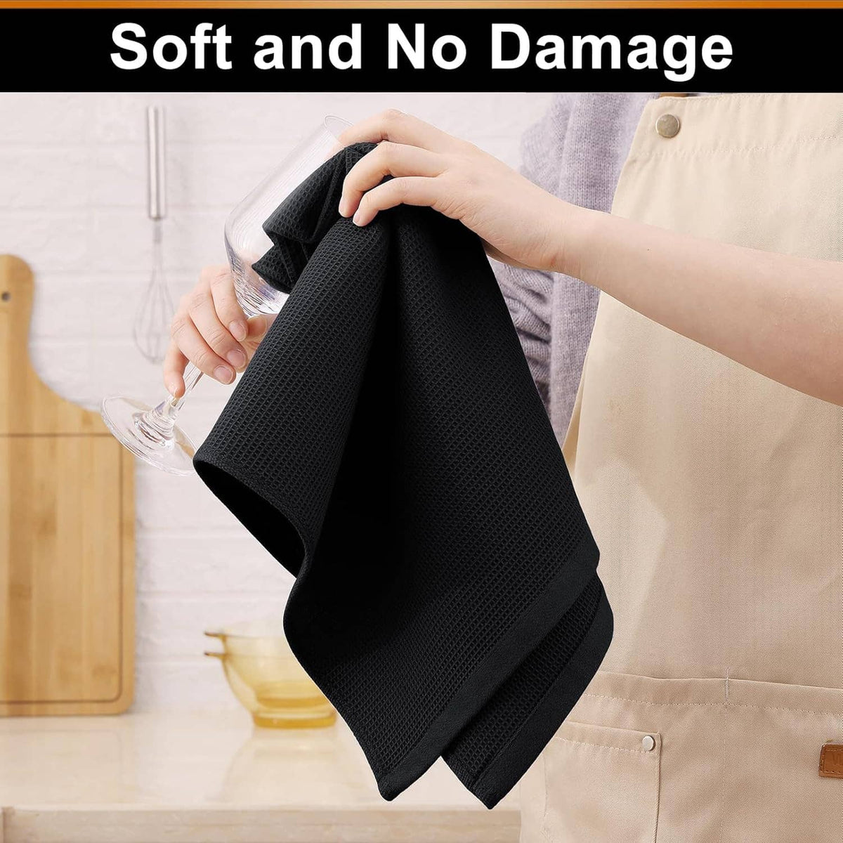 Black waffle weave cotton kitchen towel, folded and held by hands