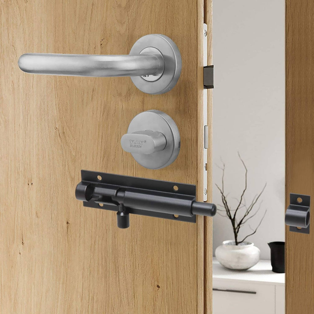 Black slide barrel bolt latch installed on a wooden door with mounting plates