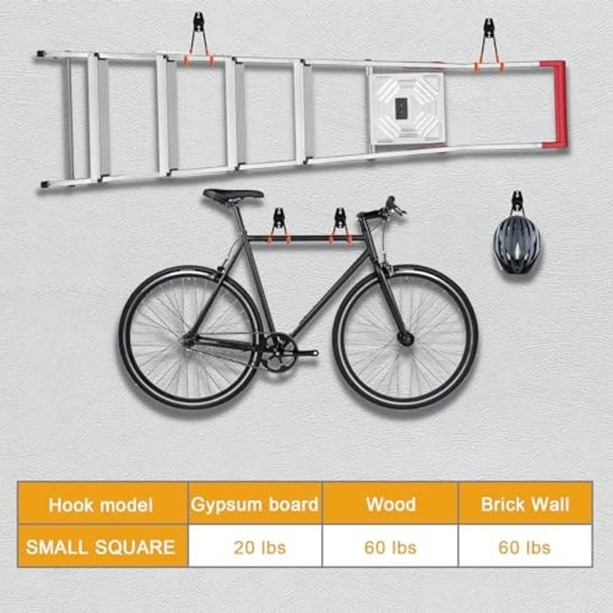 Multiple wall hooks installed in a garage grid, black brackets with orange rubber ends