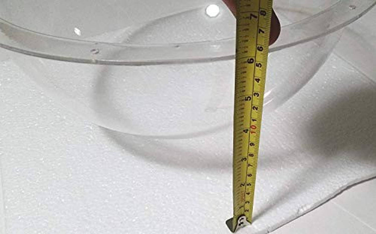 Clear plastic hemisphere dome with vertical ruler measurement at edge.