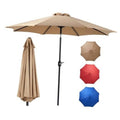 Tan patio umbrella with crank pole and tilt canopy, plus hanging spare fabric panels
