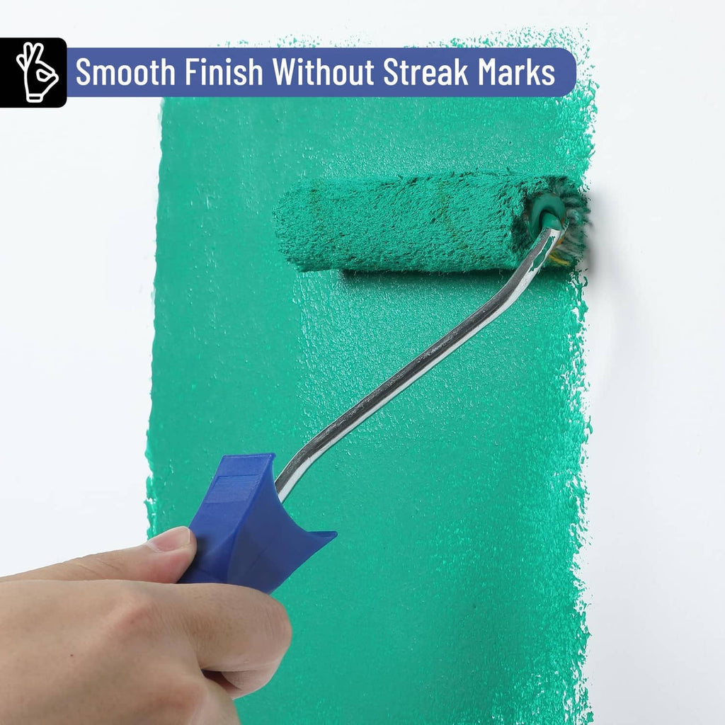 Blue-handled paint roller spreading green paint on a wall