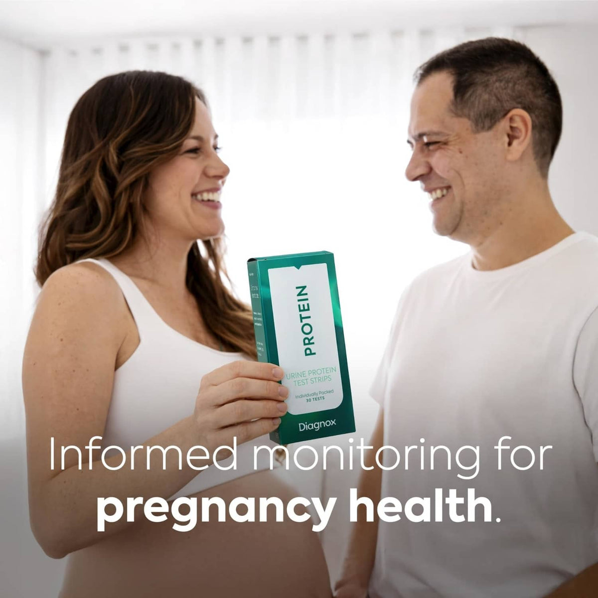 Urine protein test strips box held by a couple for home monitoring