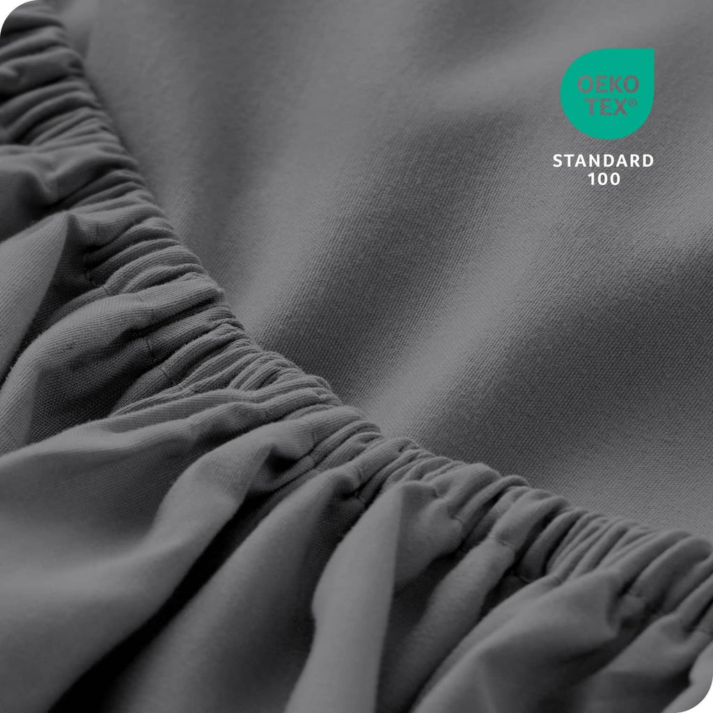 Grey microfiber fitted sheet close-up with OEKO-TEX Standard 100 label