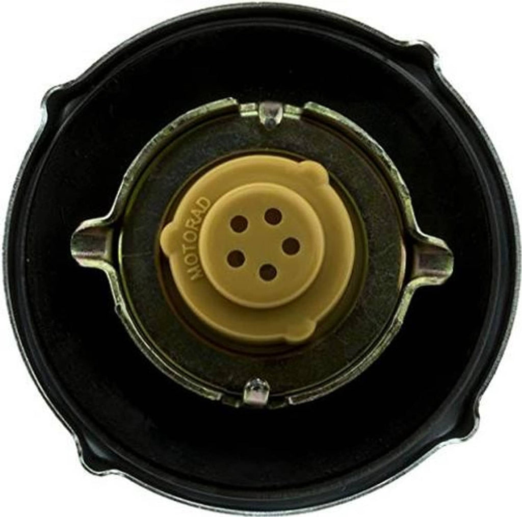 Fuel tank cap with black outer ring and yellow circular locking insert, three holes visible