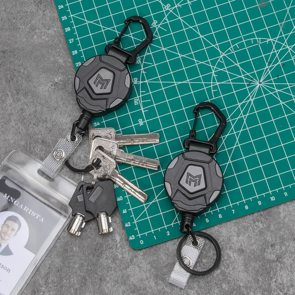 Retractable keychain badge holder set with black carabiners, metal keys, and round keyring