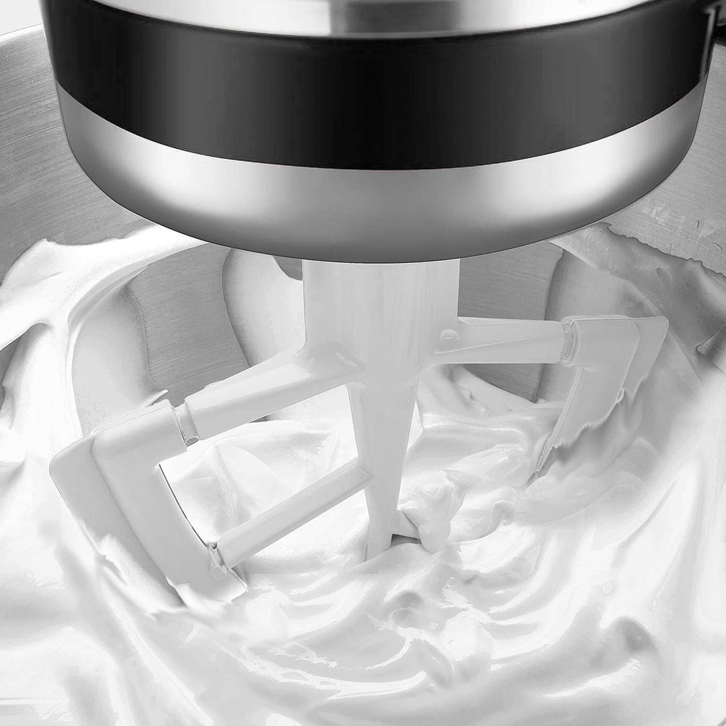 White flexible edge beater attachment inside bowl, showing curved blades underneath