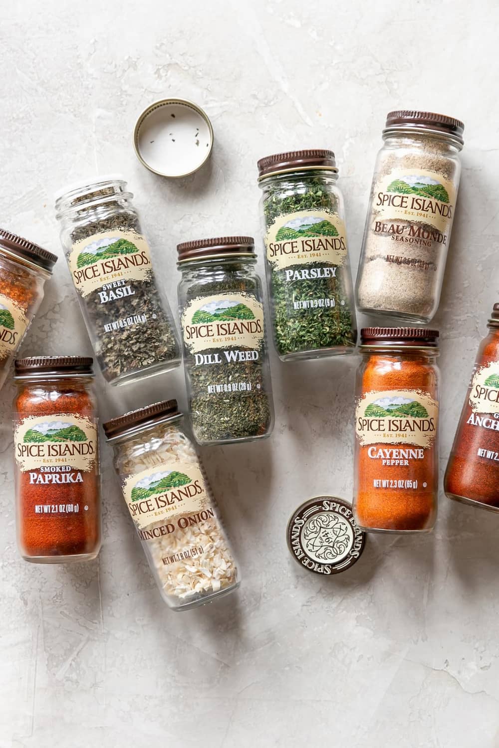 Assorted Spice Islands spice jars in different colors and granules on a tabletop