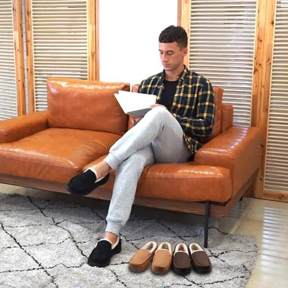 Brown moccasin slippers pair beside sofa, plush-lined interior visible