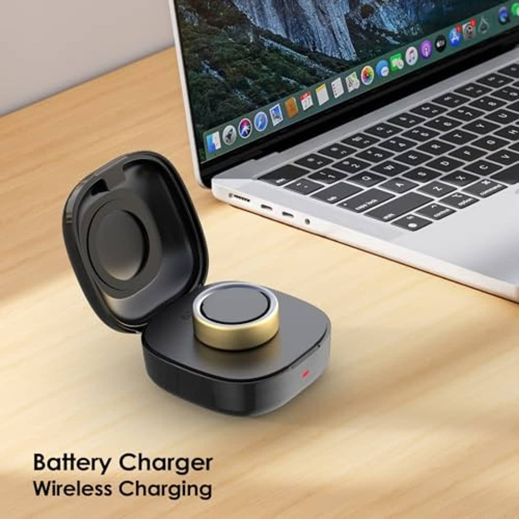 Black wireless charging dock case with gold pad on desk near laptop