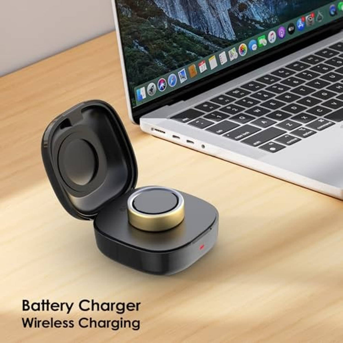 Black wireless charging dock case with gold pad on desk near laptop