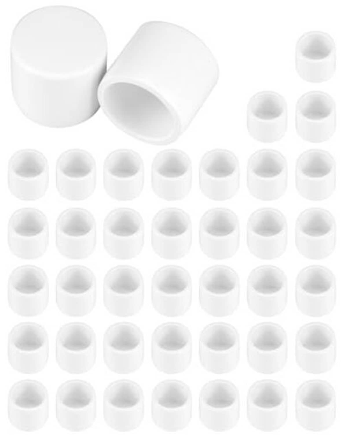 White PVC pipe end caps set with hollow openings, stacked and angled plugs