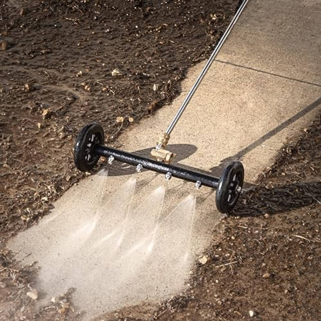 Undercarriage pressure washer cleaner spraying water along a driveway edge
