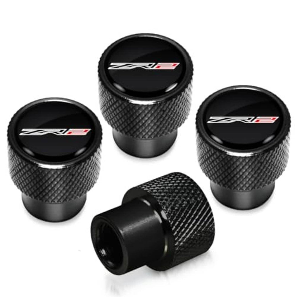 Four black textured tire valve stem caps with ZR2 logo and matching caps