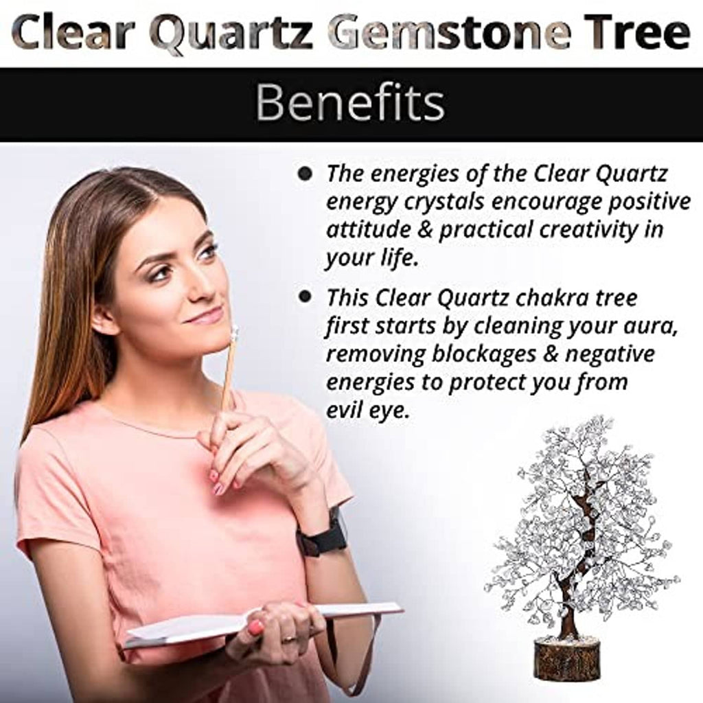 Clear quartz gemstone tree on a round wooden base with textured crystal branches