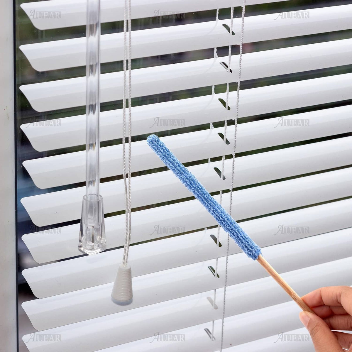 Blue microfiber duster stick cleaning window blinds, with wooden handle