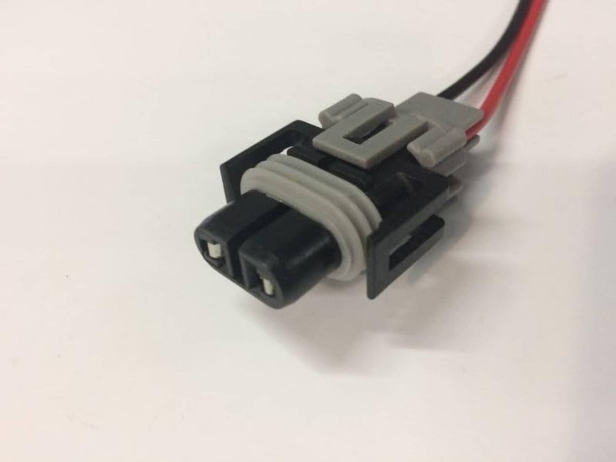 Dual-pin wire connector housing with red/black leads, gray and black plastic