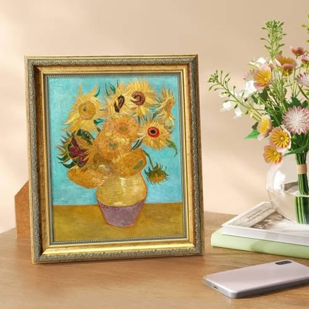 Vintage ornate gold picture frame with clear glass, featuring colorful bird artwork in a pot