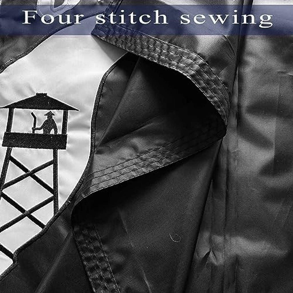 Outdoor flag panel, black with visible four-row stitching and embroidered scene emblem