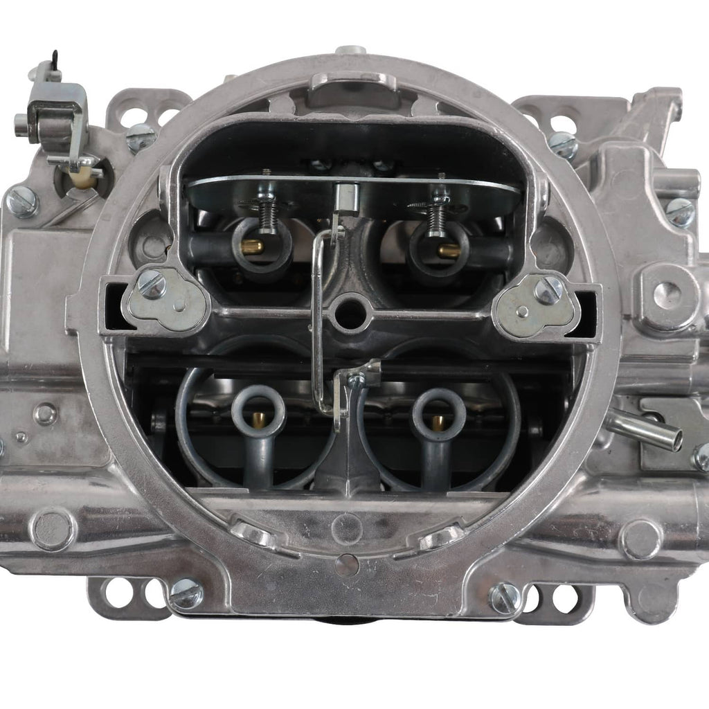 Carburetor interior close-up with dual throttle bores and metal air passages