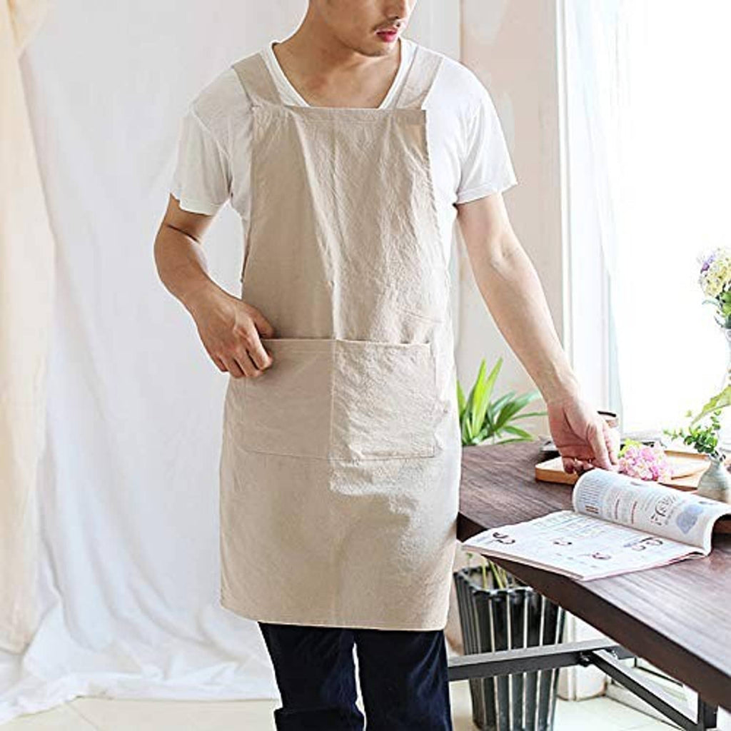 Light beige cooking apron with two front pockets and cross-back shoulder straps