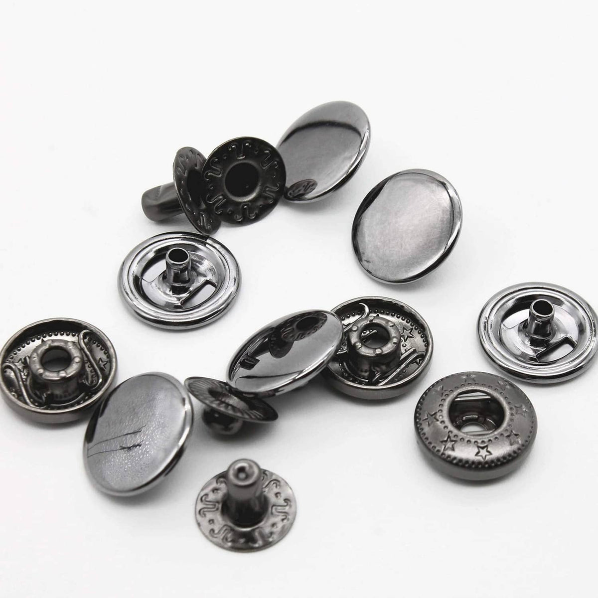 Round metal snap buttons in black and silver finishes, mixed hardware parts