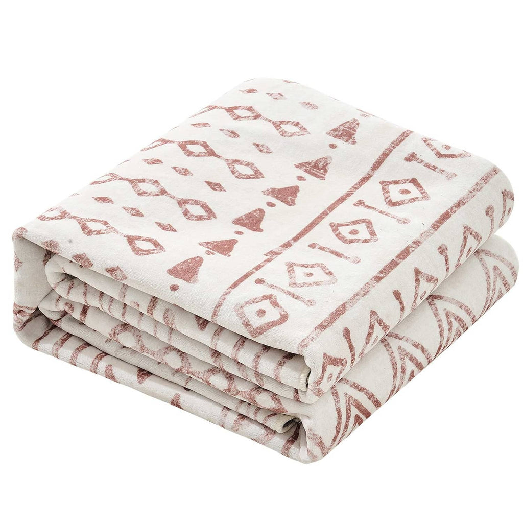 Folded beige geometric area rug with brown and rust pattern