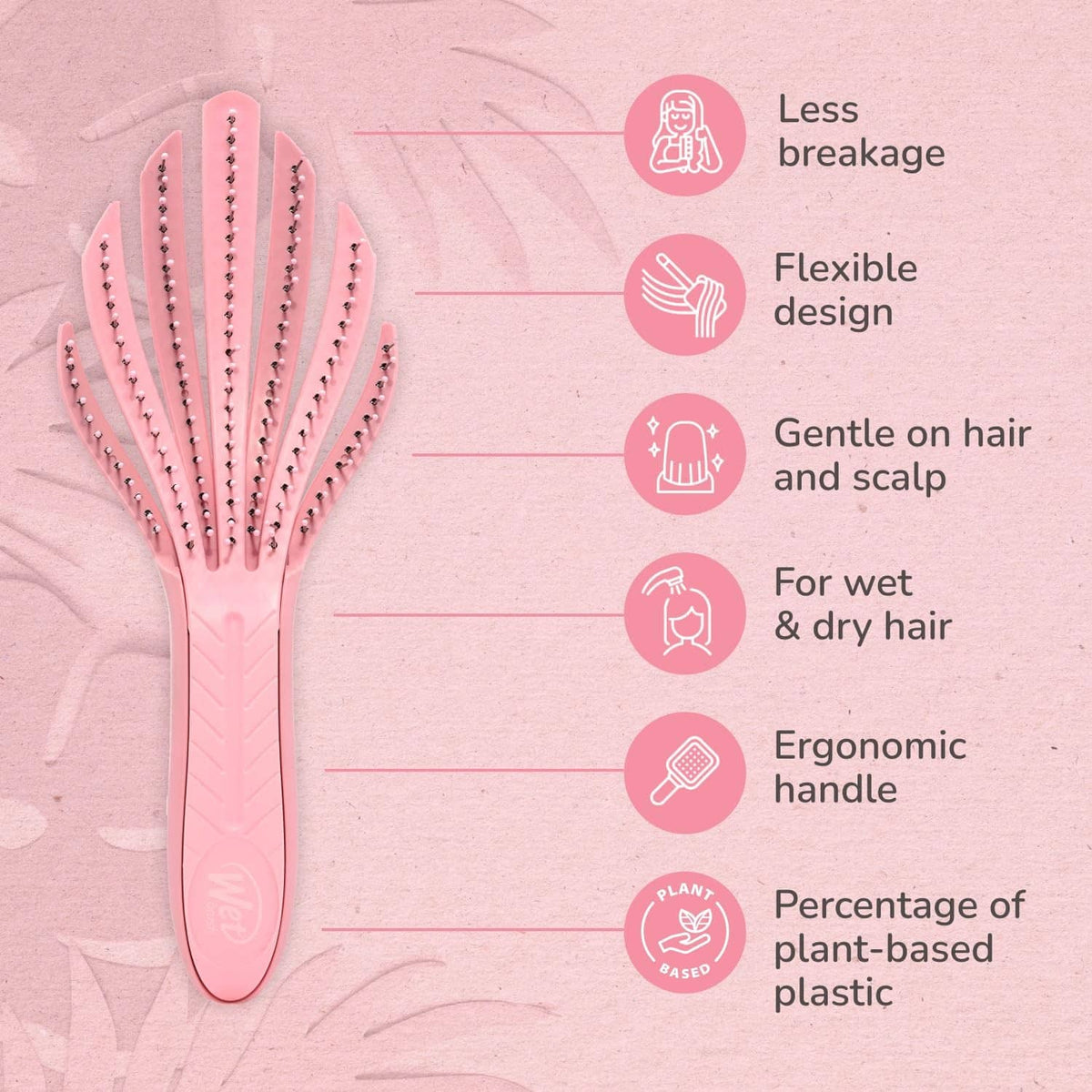 Pale pink curl detangler hair brush with pointed bristles on a cushioned pad