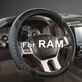 Black steering wheel cover with white stitched edge and quilted pattern over wheel rim