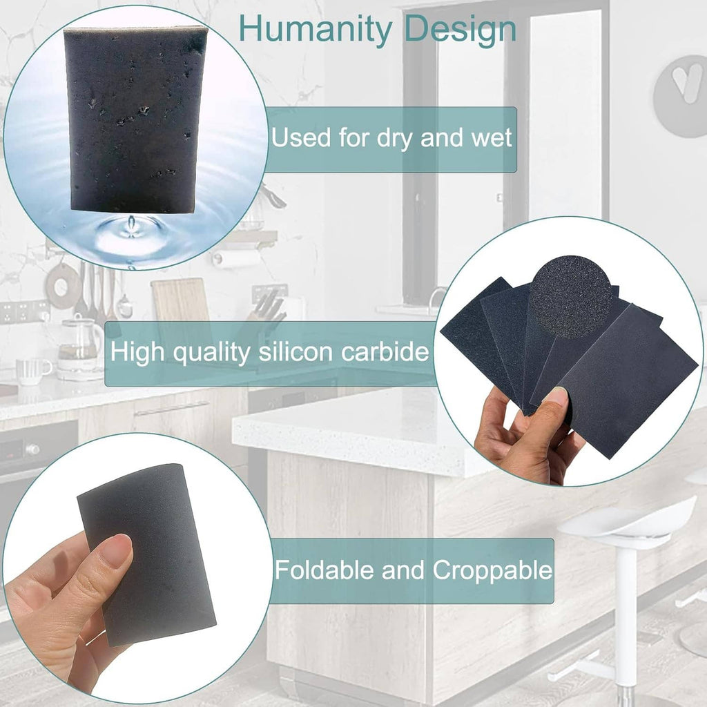 Dark blue sanding sponge pads, stacked and held in hand
