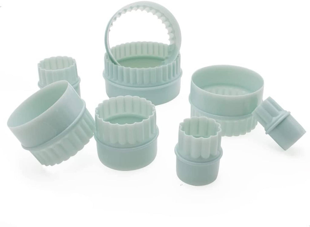 Eight light mint bowl risers with scalloped sides and loop handle centerpiece