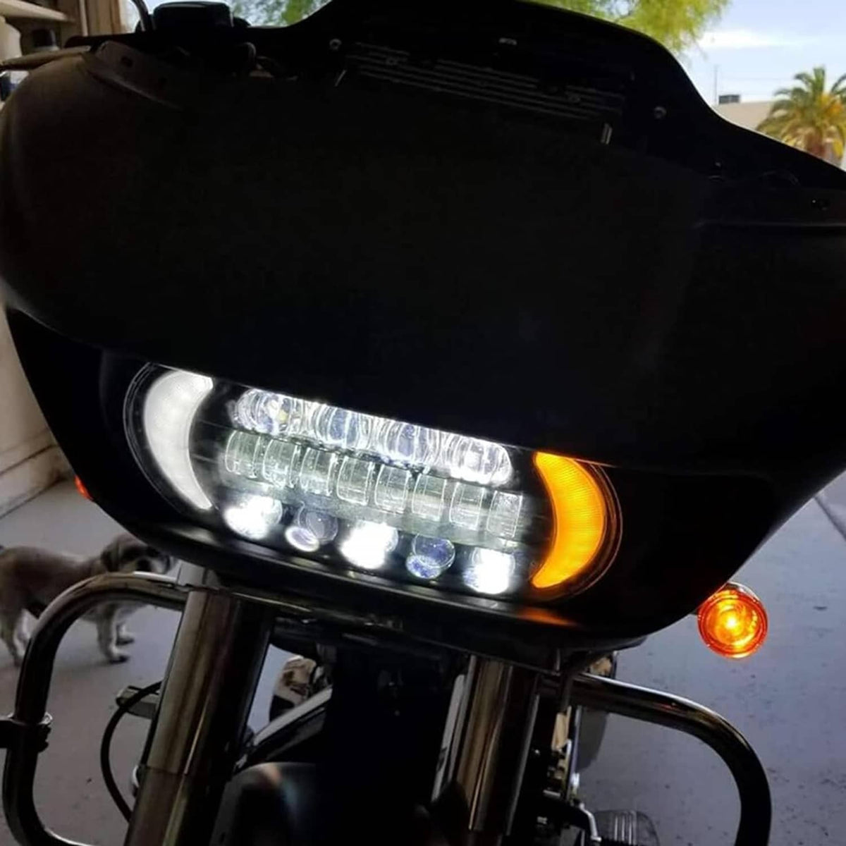 LED headlight with lit white strip DRL and amber turn-signal glow on motorcycle