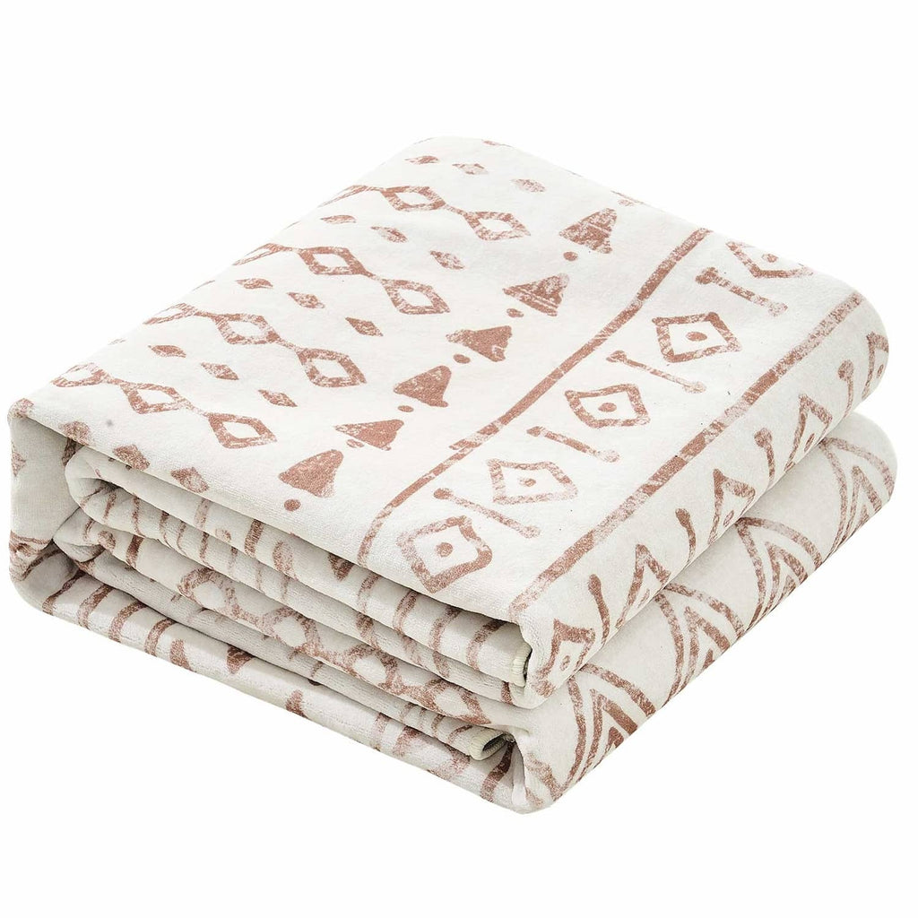 Beige patterned large area rug, folded stack with geometric motifs and borders