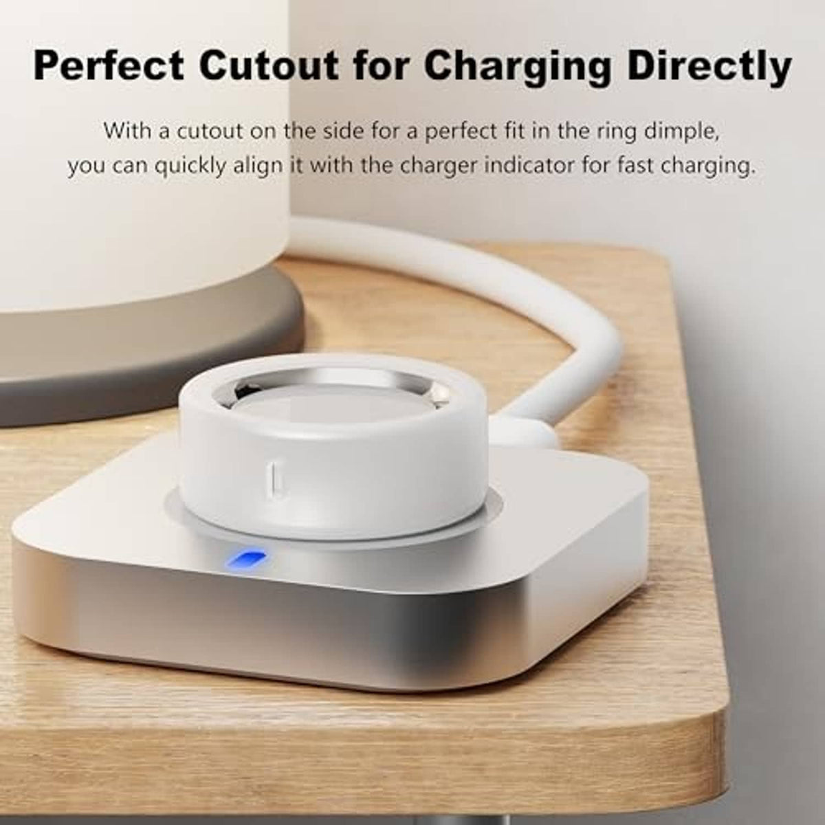 White silicone ring protector with side cutout, docked on a charging base