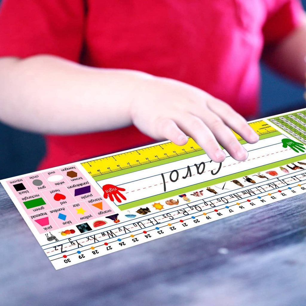 Self-adhesive nameplate strip on desk with hand applying, '10 AM' text