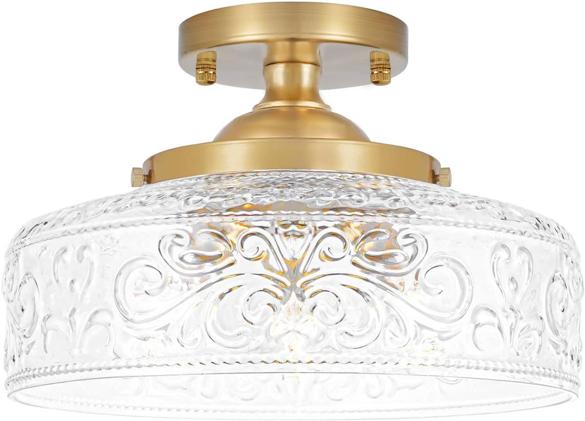 Front view of gold semi-flush ceiling light with textured clear glass globe shade