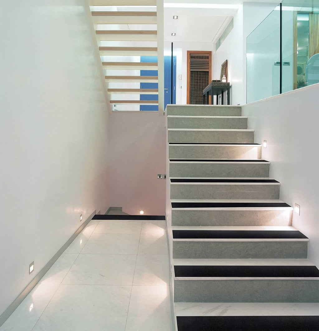 Anti-slip tape strips on modern indoor staircase steps, dark gray traction bars