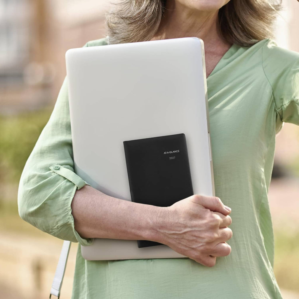 AT-A-GLANCE 2027 black planner cover held in hand