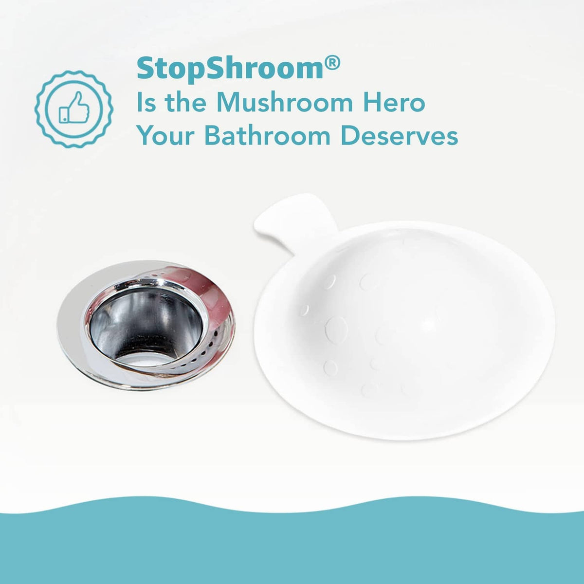 White mushroom-shaped silicone drain cover placed beside round chrome drain