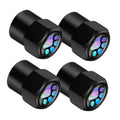 Set of 4 black hexagonal alloy tire valve stem caps with glowing paw prints