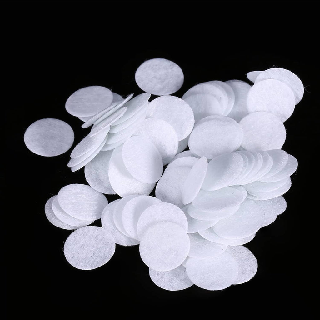 White microdermabrasion cotton filter discs, stacked and loose round pads